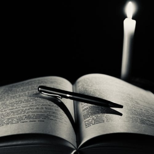 Ordinary pen, book and candle