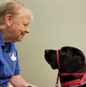 Service Dog, Dekker, looking at ARdis Mayo has words of wisdom