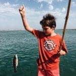 Boy showing the fish he caught