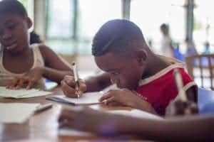 Boy learning to write with pen