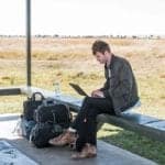 Man on bench with digital journal