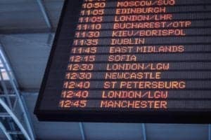 An overhead arrival board in an airport