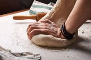 Two hands kneading dough as a way to lament