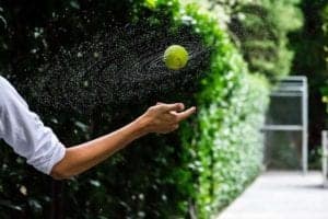 An outstretched hand bouncing a ball in mid-air