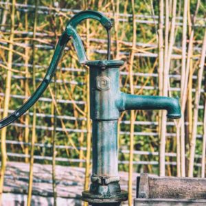 an old fashioned hand pump used to draw water from a well