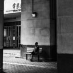 Man waiting in train station on a bench