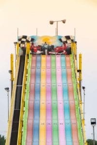 multi colored slides at the fair for a thrill ride