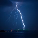 Lightning strike against a blue sky