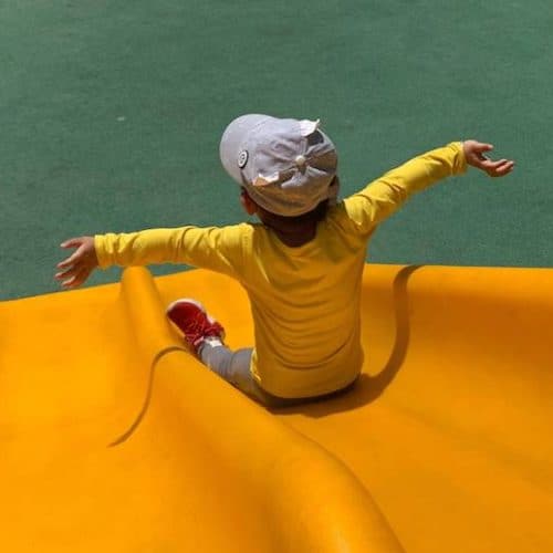 Boy at the end of a thrilling slide