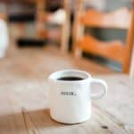white mug of coffee on a table
