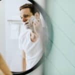 Man shaving in mirror