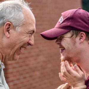 Older man smiling at younger man