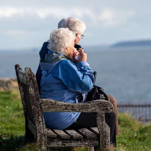 two white haired aging ladies on a bench discussing the meaning and purpose of growing old