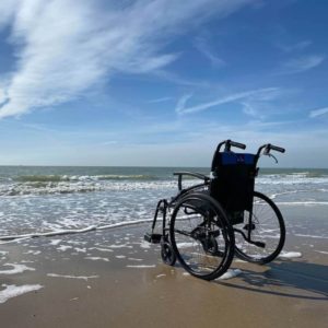 empty wheelchair on a beach