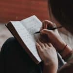 girl writes in journal