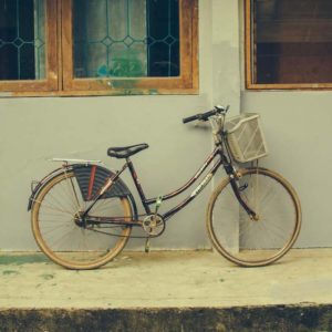 old Schwinn bike leaning against a wall