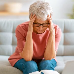 exhausted woman with head in her hands