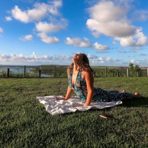 woman doing yoga in open field while on personal retreat