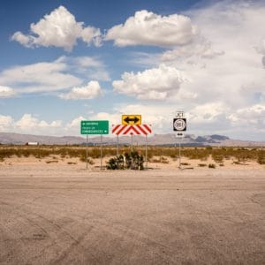 group of road signs at the end of a road