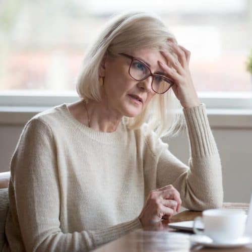 weary woman at her desk