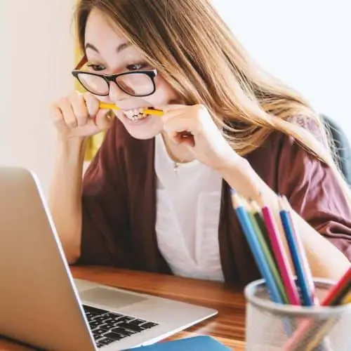 Woman under stress chews on a pencil