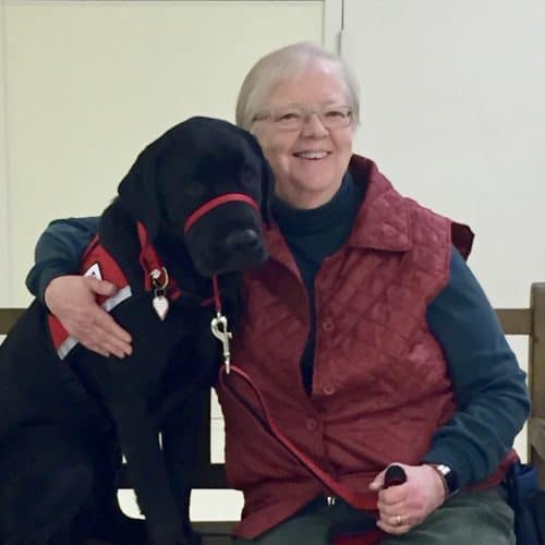 Dekker, a service dog, with the author Ardis Mayo