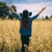 woman lifting arms in gratitude