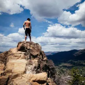 man at top of cliff