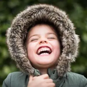 happy child wearing a parka