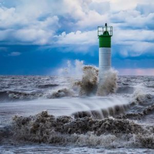 raging-ocean around a lighthouse