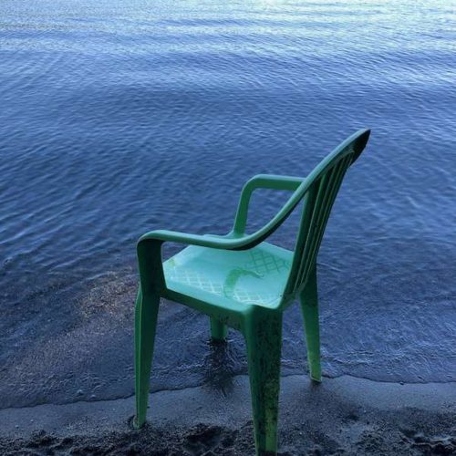 learning to sit - a chair by the edge of a lake