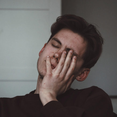 man in grief holding face with his hand Ardis Mayo