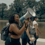 female activist passionate about using her voice for change with a bullhorn