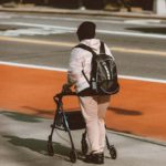 Man walking with assistive device called a walker