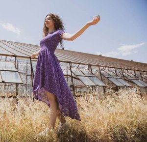 A young woman wears a purple dress enjoys the importance of sabbath rest