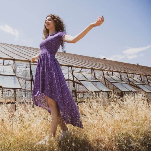 A young woman wears a purple dress enjoys the importance of sabbath rest