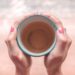 Being still holding a cup of tea, looking for peace and resilience; prayer