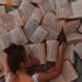 woman face down on a lot of open books; consumption vs digestion