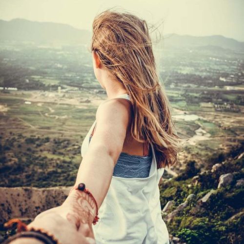 woman clinging to hand but looking at horizon. Does she want to say no?