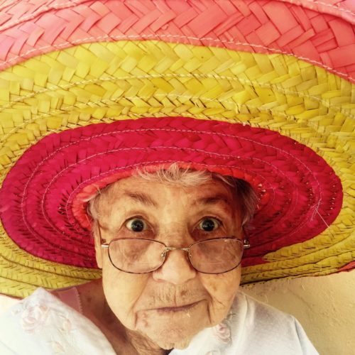 old woman having fun wearing colorful hat