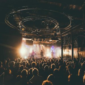 concert with people listening to singers