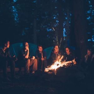 magic of we experienced by circle of people around a campfire