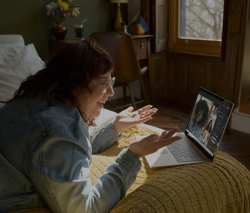 a woman uses her laptop computer as technology for spiritual growth by connecting with friends all over the world