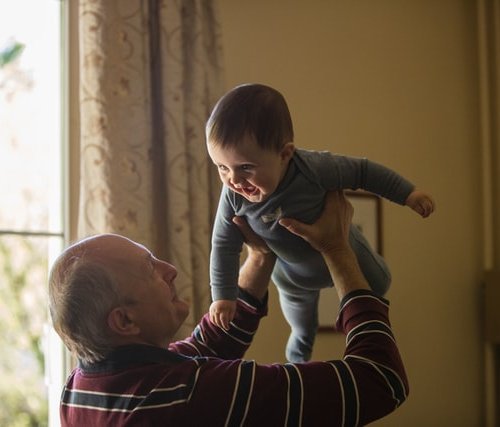mans plays with grandson, aging over youth