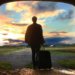 man facing sunset with suitcase in his hand. HOw to say goodbye