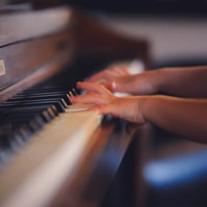 child practicing piano