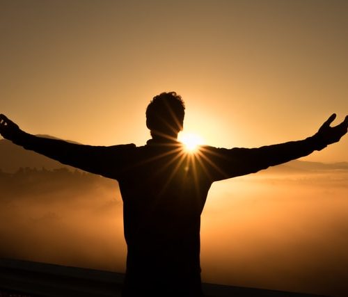 man who knows how to live fully lifts his arms to the sunset