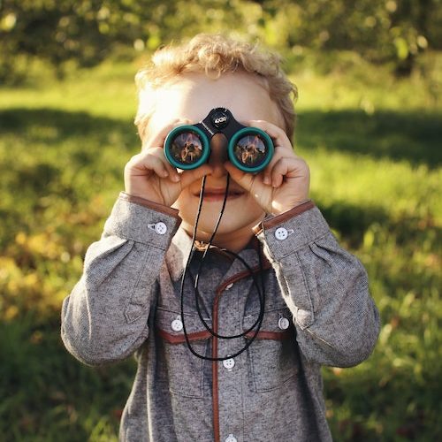 boy looks through binoculars to find god,Ardis Mayo