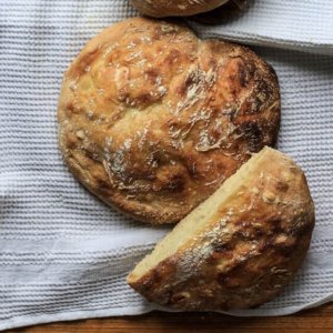 Ardis Mayo, a loaf of homemade bread broken