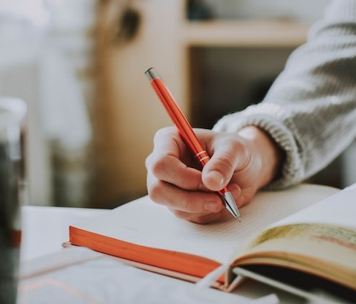 woman journaling to-do list and goals